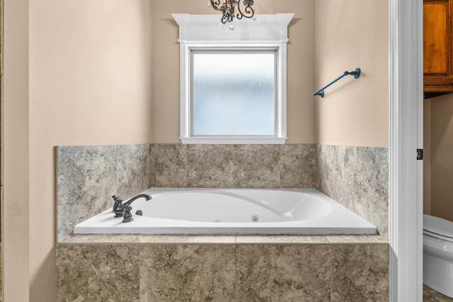 bathroom featuring a relaxing tiled tub and toilet