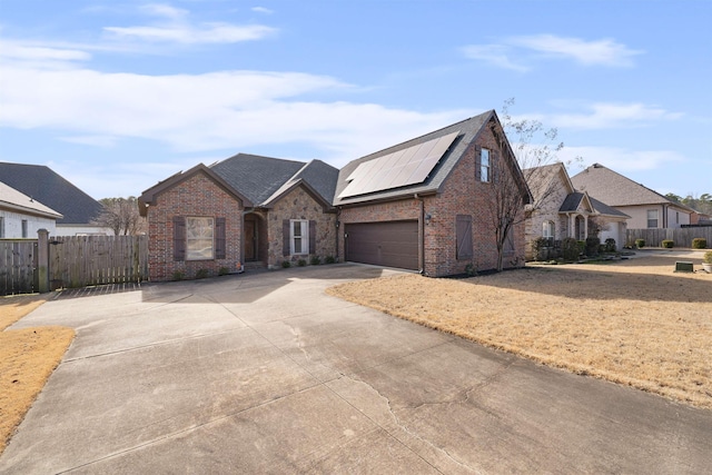 view of front of home with a garage and solar panels