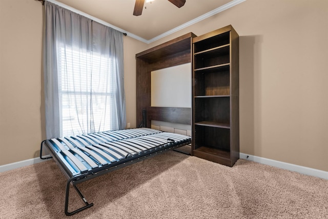 unfurnished bedroom featuring crown molding, ceiling fan, and carpet flooring