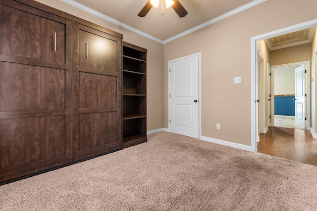 unfurnished bedroom with crown molding, ceiling fan, and carpet flooring