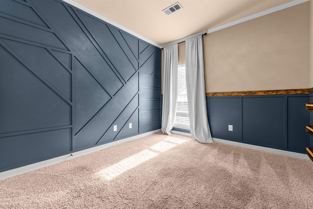 unfurnished room featuring crown molding and carpet