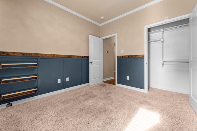 unfurnished bedroom featuring crown molding, carpet floors, and a closet