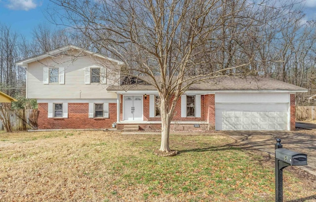 view of front of house featuring a garage and a front lawn