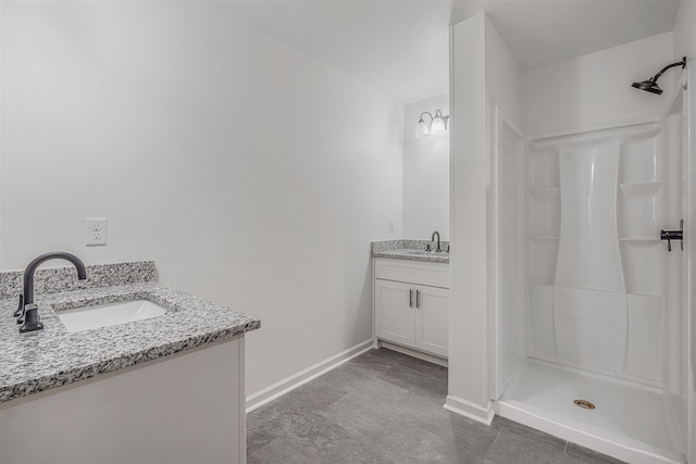 bathroom with walk in shower and vanity