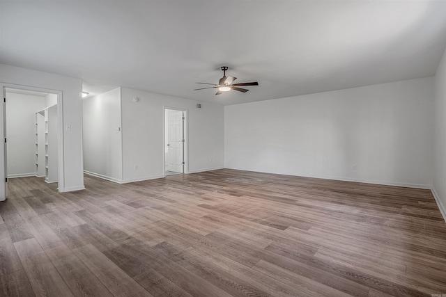 spare room with ceiling fan and light wood-type flooring