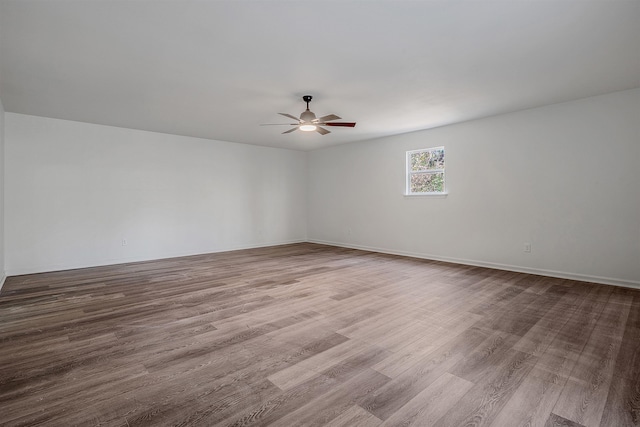 unfurnished room featuring hardwood / wood-style floors and ceiling fan