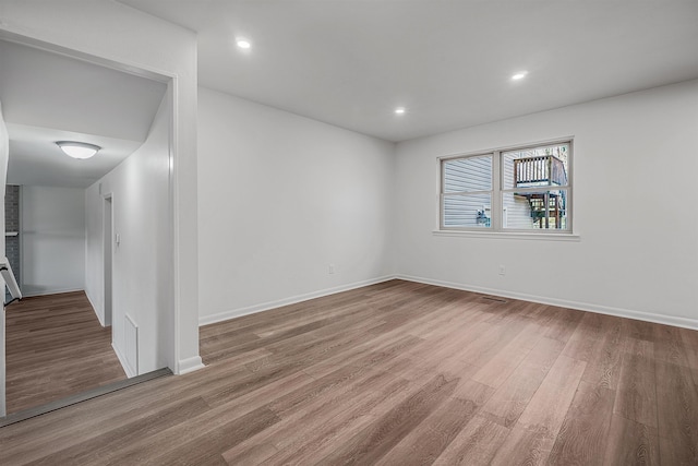 unfurnished room with wood-type flooring