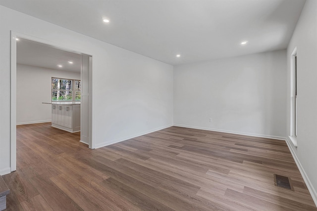 spare room with hardwood / wood-style flooring