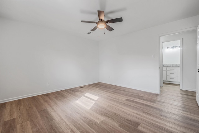 empty room with ceiling fan and light wood-type flooring