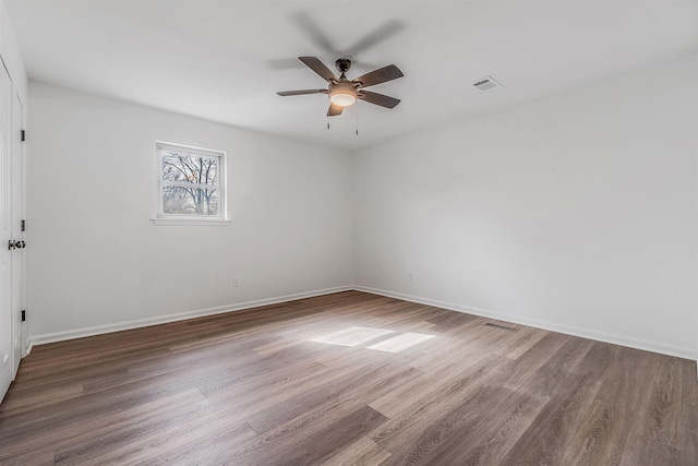 empty room with hardwood / wood-style floors and ceiling fan