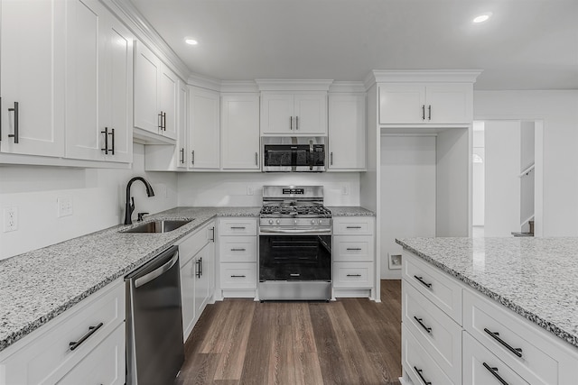 kitchen featuring stainless steel appliances, sink, and white cabinets