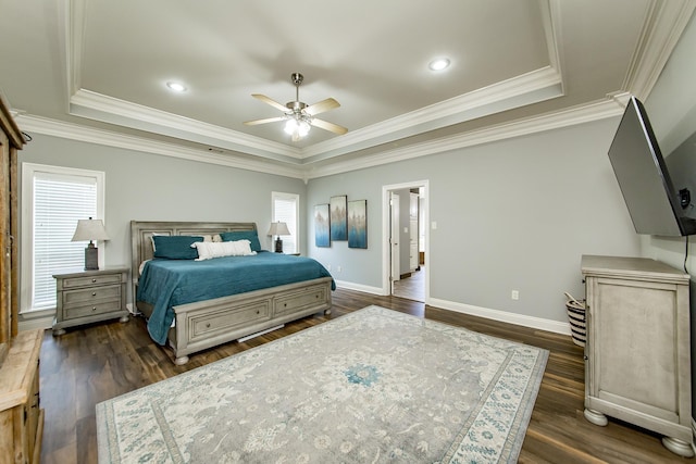 bedroom featuring a tray ceiling, dark wood-type flooring, and ornamental molding