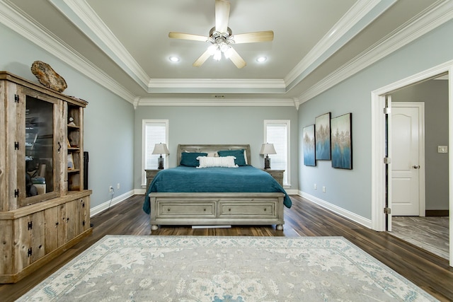 bedroom with crown molding, ceiling fan, a tray ceiling, and dark hardwood / wood-style flooring