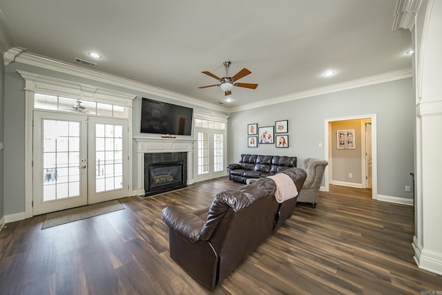 living room with dark hardwood / wood-style flooring, a high end fireplace, ornamental molding, and french doors