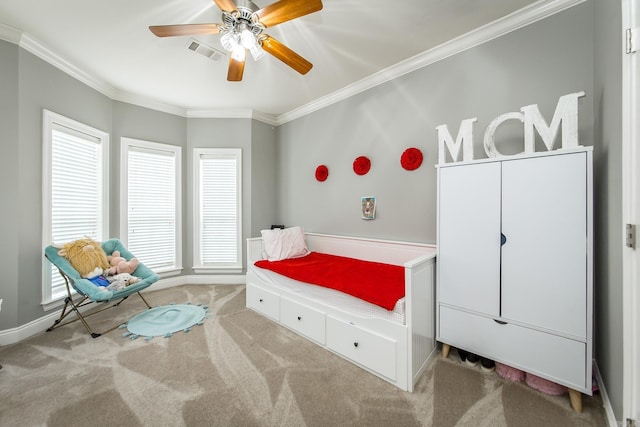 carpeted bedroom featuring ceiling fan and ornamental molding