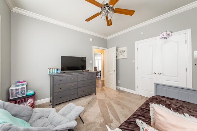 carpeted bedroom featuring crown molding and ceiling fan