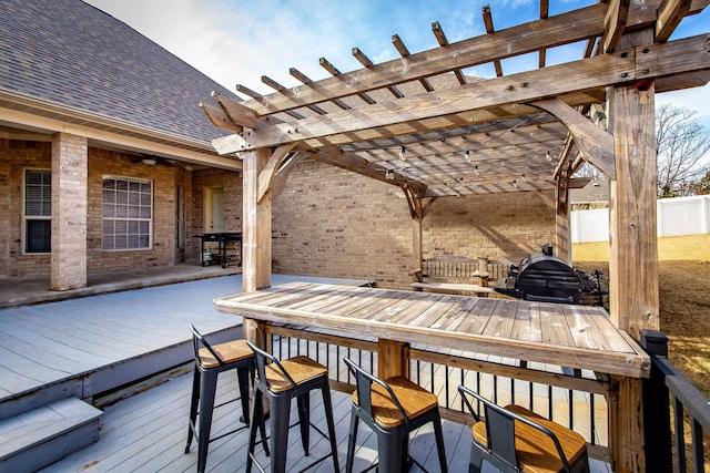 deck with a pergola and an outdoor bar