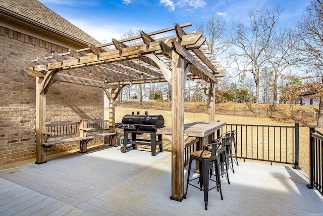 view of patio / terrace featuring a wooden deck, a grill, an outdoor bar, and a pergola