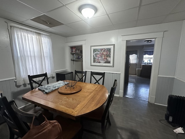 dining space featuring a drop ceiling