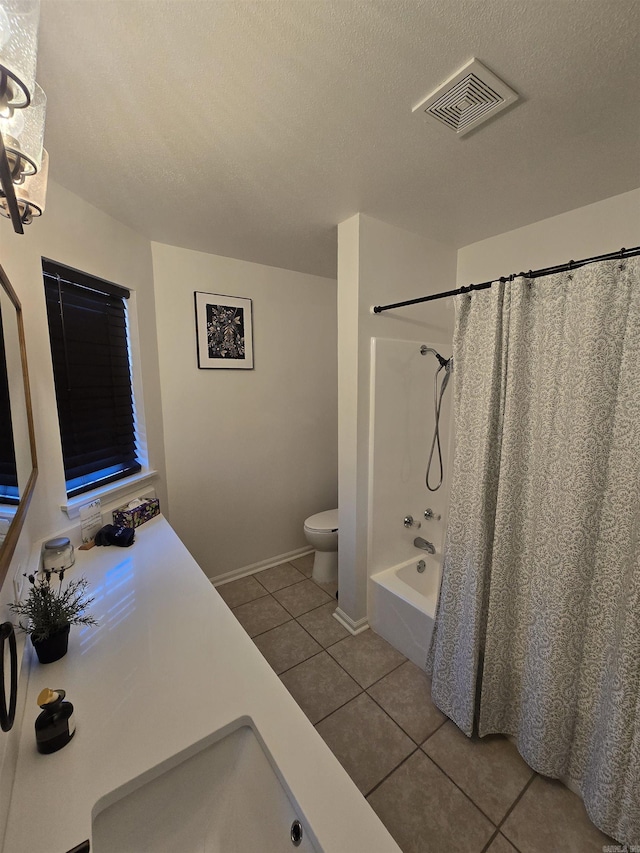 full bathroom with tile patterned flooring, shower / tub combo, a textured ceiling, and toilet