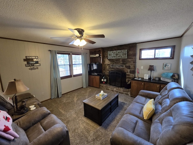 living room featuring crown molding, a stone fireplace, dark carpet, and a wealth of natural light