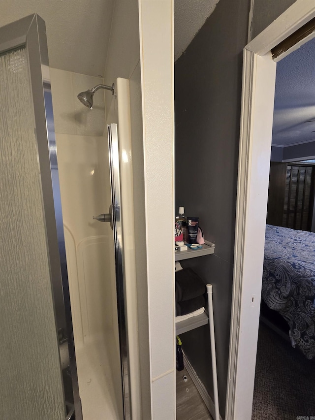 bathroom featuring hardwood / wood-style flooring and an enclosed shower