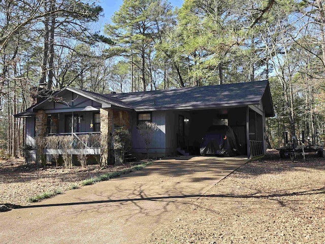 ranch-style home featuring a carport and a porch