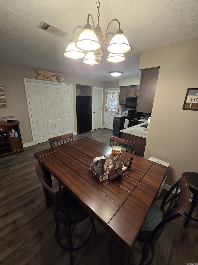 dining area with dark hardwood / wood-style floors and a textured ceiling