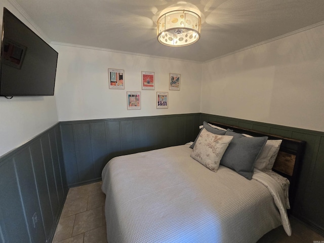 bedroom with crown molding and light tile patterned floors