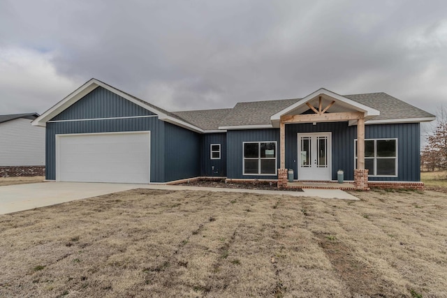 view of front of house featuring a garage and a front lawn