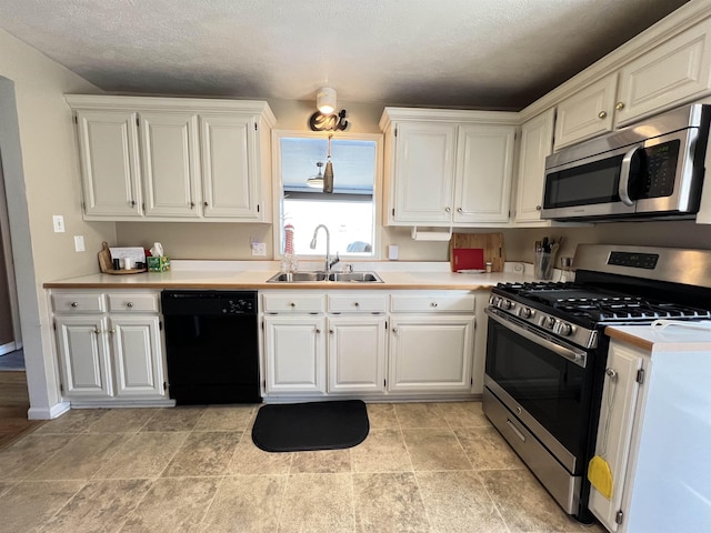 kitchen featuring sink, stainless steel appliances, and white cabinets