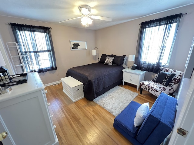 bedroom with light hardwood / wood-style flooring and ceiling fan