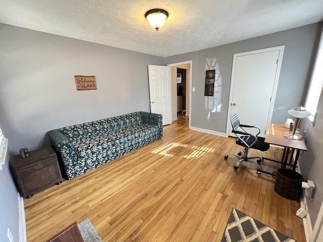 office featuring hardwood / wood-style floors and a textured ceiling