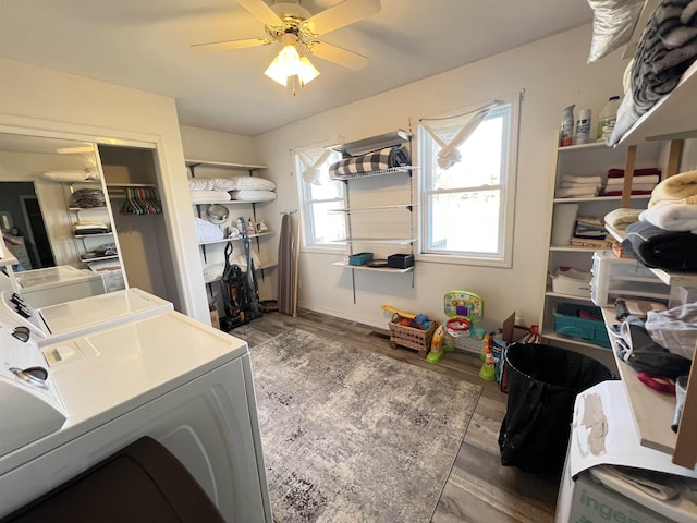 clothes washing area with hardwood / wood-style flooring, washer and dryer, and ceiling fan