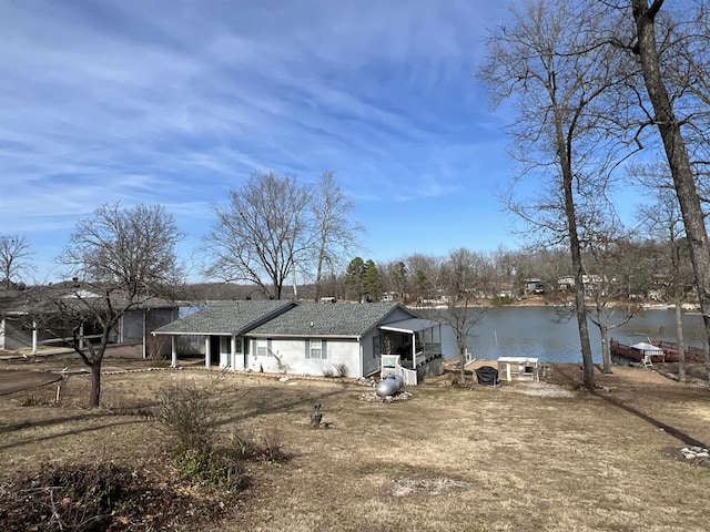 back of property featuring a water view