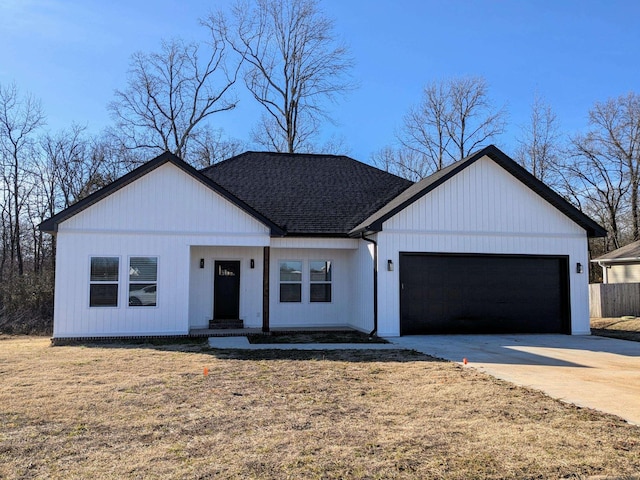 modern farmhouse style home with concrete driveway, a shingled roof, a front lawn, and an attached garage