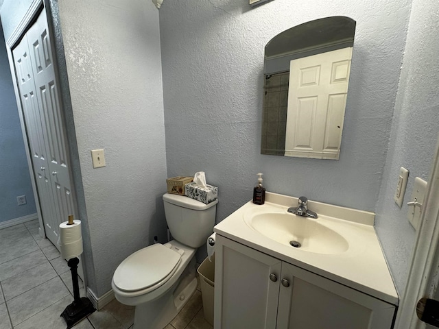 bathroom with tile patterned floors, vanity, and toilet