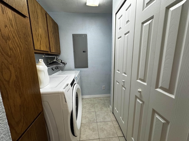 laundry room with cabinets, light tile patterned flooring, separate washer and dryer, and electric panel