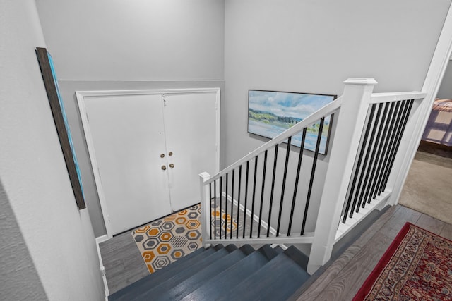 staircase featuring wood-type flooring