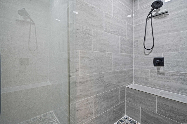 bathroom with a tile shower