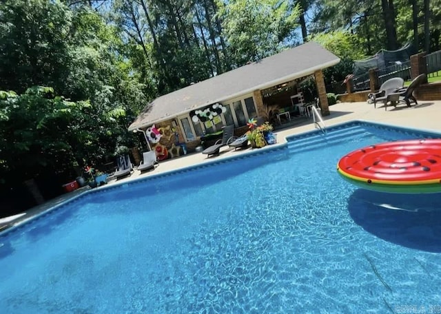 view of swimming pool with a patio area