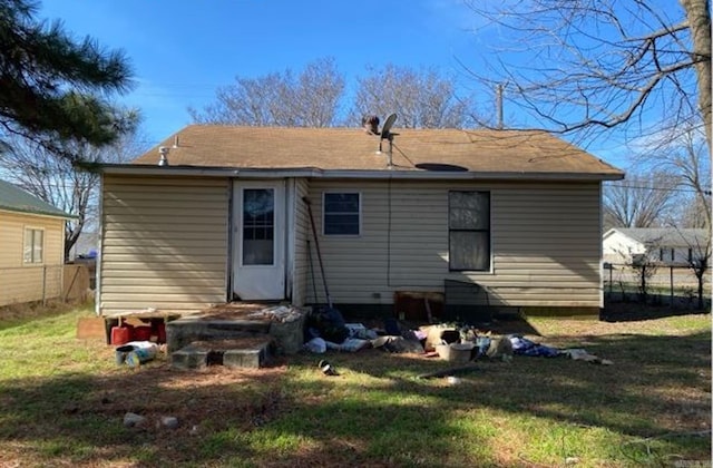 rear view of property with a lawn