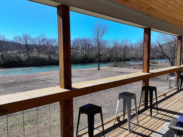 wooden deck with a water view