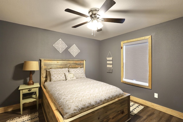 bedroom featuring ceiling fan and dark hardwood / wood-style flooring