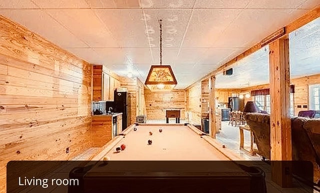 recreation room featuring wood walls