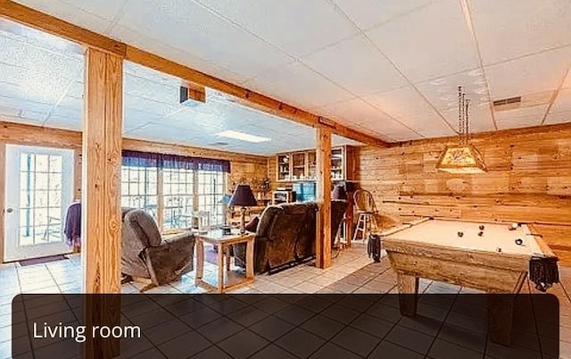 interior space featuring pool table, tile patterned floors, and wooden walls