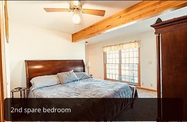 bedroom featuring ceiling fan, carpet, and beam ceiling