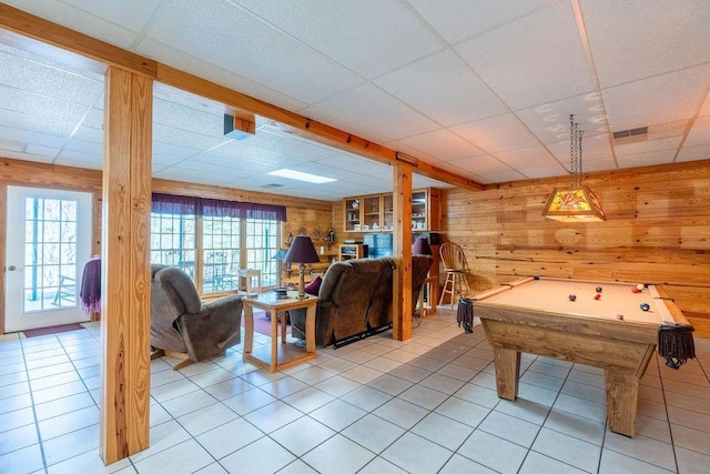 recreation room featuring light tile patterned flooring, a paneled ceiling, wooden walls, and billiards