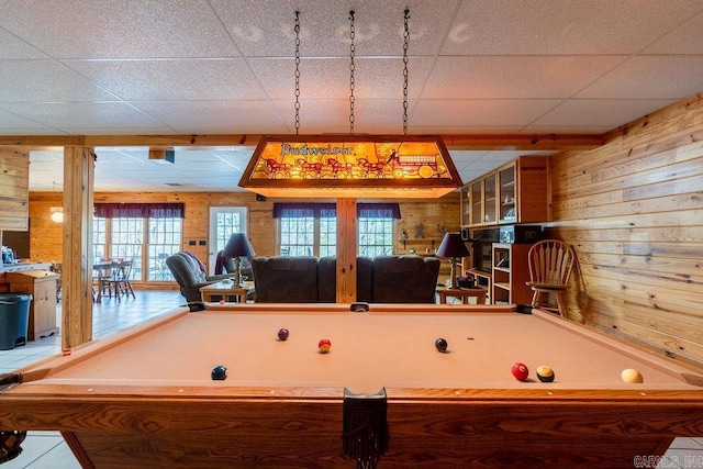 rec room with a drop ceiling, wooden walls, and billiards