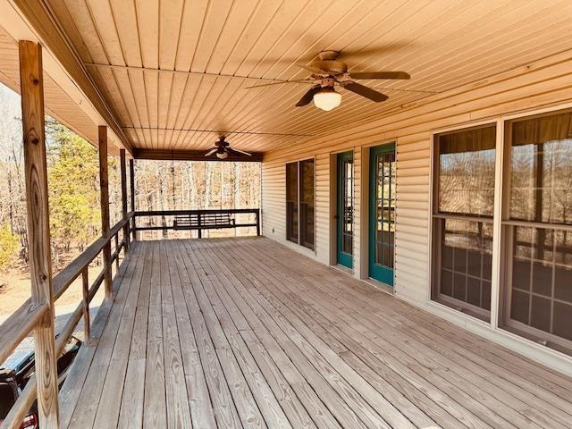 wooden deck featuring ceiling fan